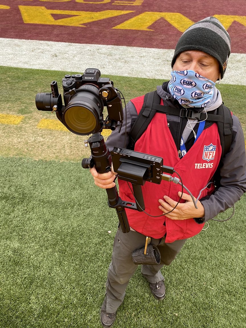 Cameraman controlling a Sony A7SIII with Cyanview on a gimbal during an NFL Game